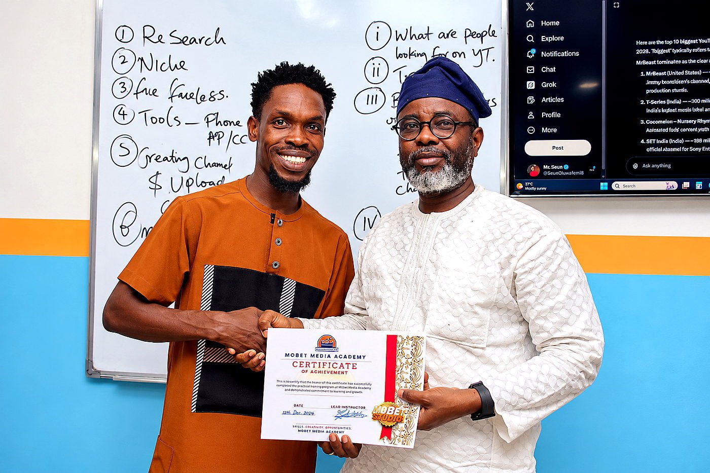 Benjamin Orji, known as Mr. Mobet, presenting a certificate to a participant